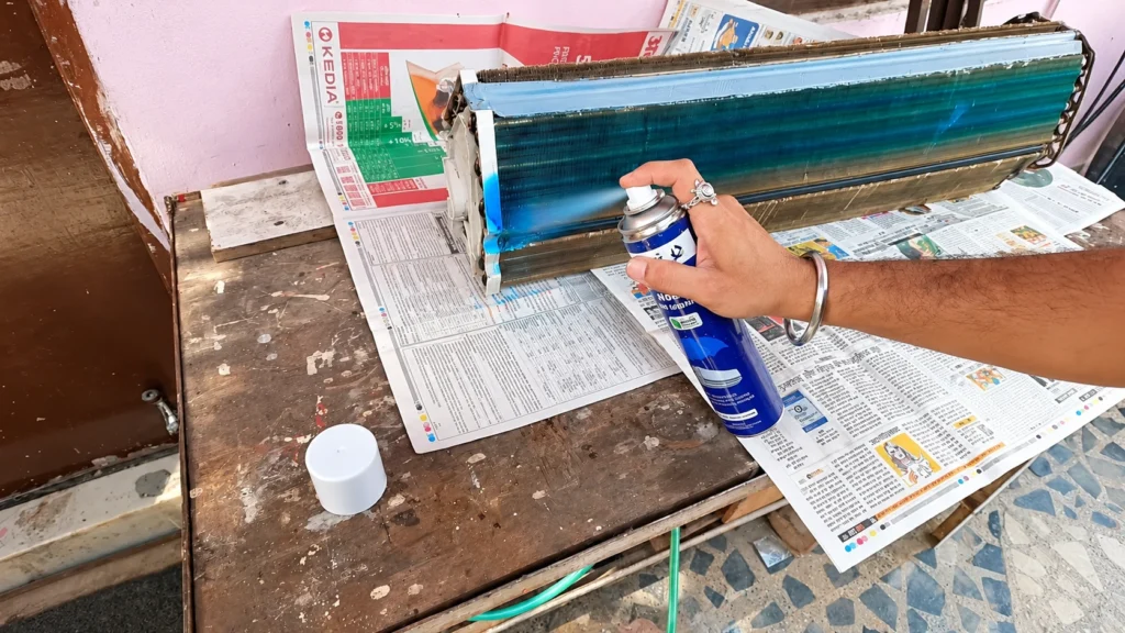 Spraying Blue Cleaner on an Evaporator Coil